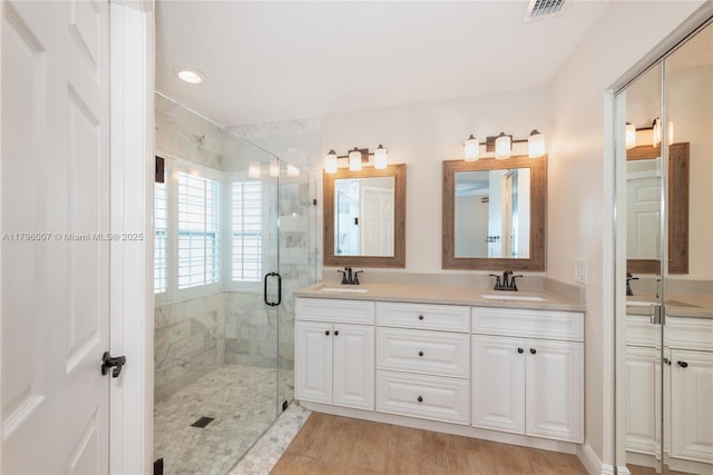 504 Bedford Ave, Weston, FL 33326 - full bath with double vanity, a stall shower, wood finished floors, and recessed lighting
