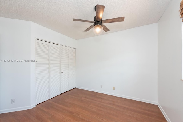 504 Bedford Ave, Weston, FL 33326 - unfurnished bedroom with wood finished floors, a closet, baseboards, and a textured ceiling