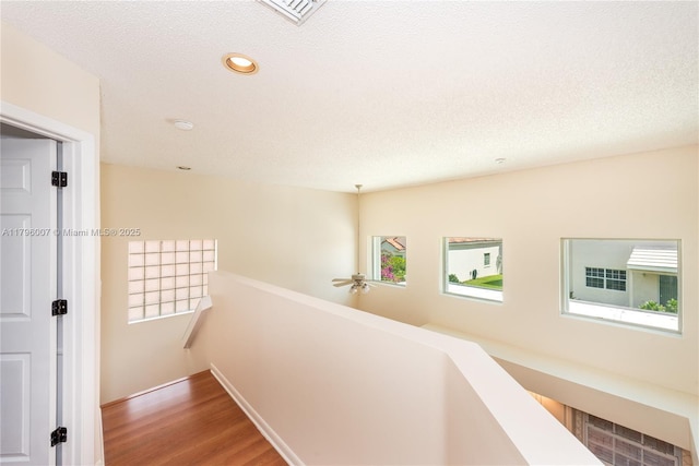 504 Bedford Ave, Weston, FL 33326 - hallway with an upstairs landing, wood finished floors, recessed lighting, and a textured ceiling