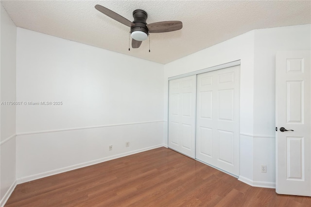 504 Bedford Ave, Weston, FL 33326 - unfurnished bedroom with wood finished floors, baseboards, a closet, a textured ceiling, and a ceiling fan