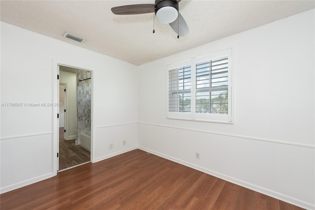 504 Bedford Ave, Weston, FL 33326 - unfurnished bedroom featuring dark wood-style flooring, a textured ceiling, a ceiling fan, and connected bathroom