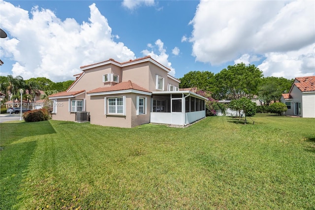 504 Bedford Ave, Weston, FL 33326 - rear view of property with stucco siding, a sunroom, a tile roof, a yard, and central AC