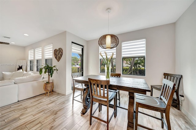 dining room with recessed lighting, baseboards, visible vents, and light wood finished floors