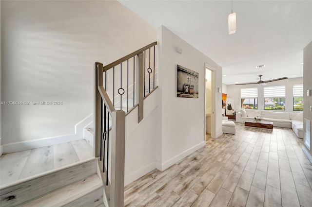 stairway with recessed lighting, baseboards, ceiling fan, and wood finished floors