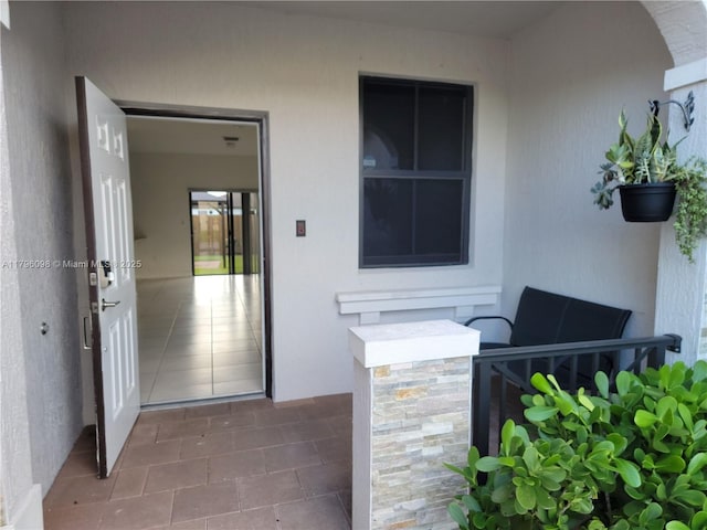 entrance to property featuring stucco siding