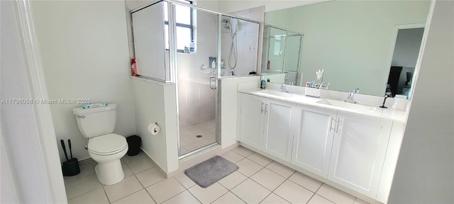 full bathroom featuring toilet, tile patterned floors, a sink, and a stall shower