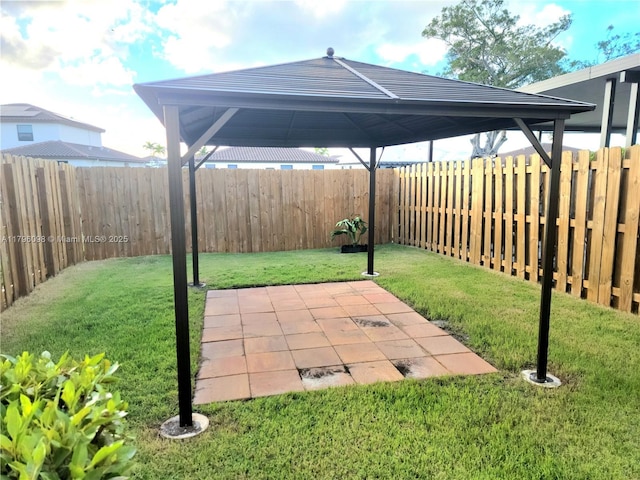 view of yard with a gazebo, a fenced backyard, and a patio