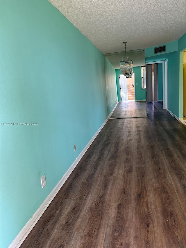9121 Sunrise Lakes Blvd Unit 120, Sunrise, FL 33322 - interior space featuring a textured ceiling, dark wood-style floors, a chandelier, and visible vents