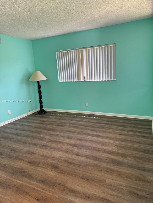 9121 Sunrise Lakes Blvd Unit 120, Sunrise, FL 33322 - empty room with baseboards, a textured ceiling, and wood finished floors