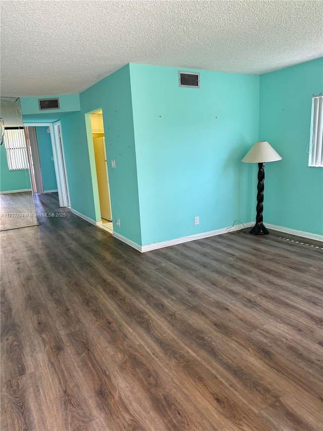 9121 Sunrise Lakes Blvd Unit 120, Sunrise, FL 33322 - spare room with dark wood-style flooring, a textured ceiling, and visible vents