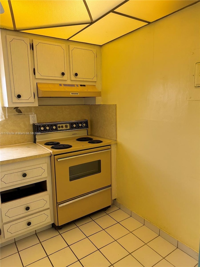 9121 Sunrise Lakes Blvd Unit 120, Sunrise, FL 33322 - kitchen featuring light countertops, white electric stove, under cabinet range hood, and light tile patterned flooring