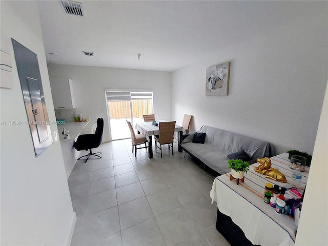 living area featuring light tile patterned floors and visible vents