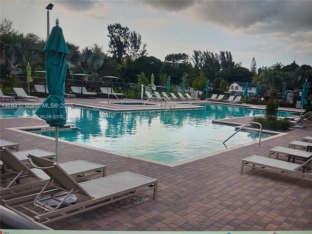 pool with fence and a patio