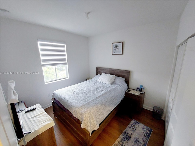 bedroom featuring baseboards and wood finished floors