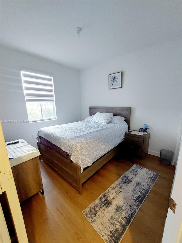 bedroom with wood finished floors