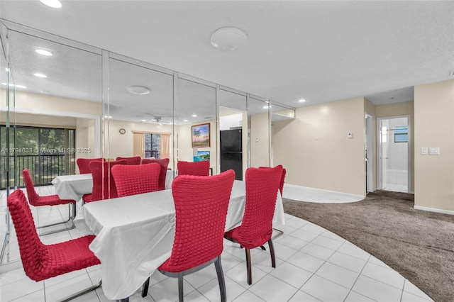 carpeted dining space with recessed lighting and baseboards