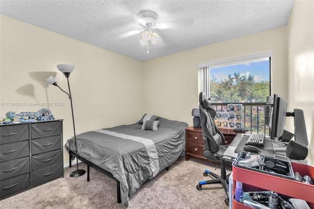 bedroom featuring carpet floors, a textured ceiling, and ceiling fan