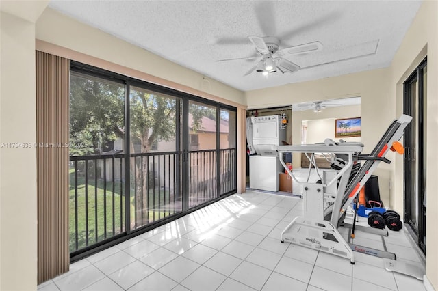 unfurnished sunroom featuring stacked washer and clothes dryer