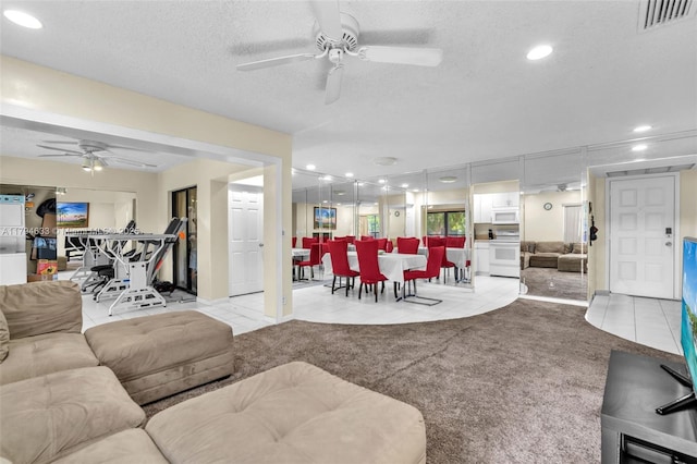 living room featuring visible vents, ceiling fan, recessed lighting, a textured ceiling, and light tile patterned floors