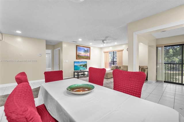 dining room featuring ceiling fan, a healthy amount of sunlight, and tile patterned flooring