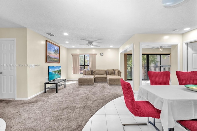 living room featuring carpet floors, visible vents, recessed lighting, a textured ceiling, and a ceiling fan