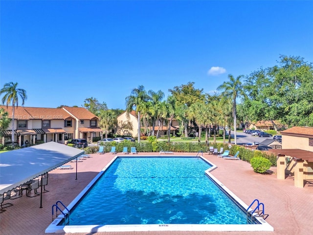 pool featuring a residential view and a patio area