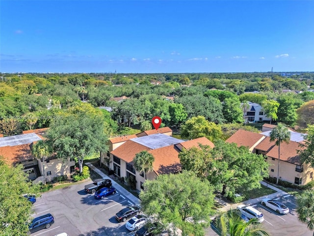 birds eye view of property with a view of trees