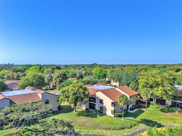drone / aerial view with a wooded view