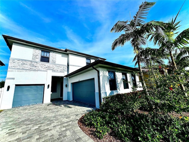 4409 SW 173rd Ave, Miramar, FL 33029 - view of front of home featuring stucco siding, stone siding, decorative driveway, and a garage