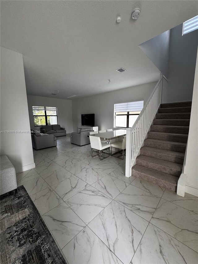 4409 SW 173rd Ave, Miramar, FL 33029 - living room with stairway, baseboards, and marble finish floors