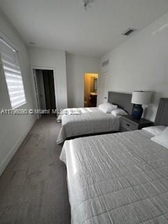 carpeted bedroom featuring baseboards and visible vents