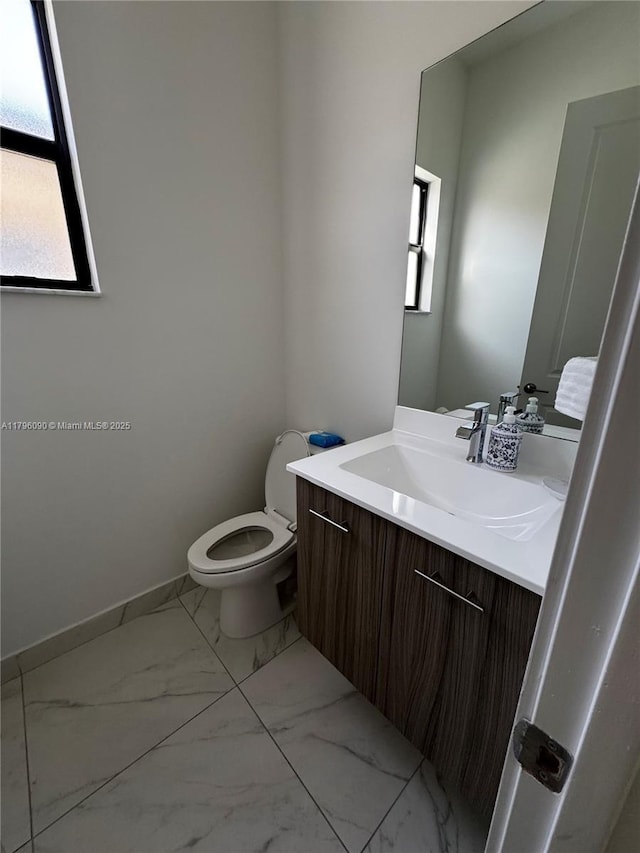 4409 SW 173rd Ave, Miramar, FL 33029 - half bath featuring marble finish flooring, toilet, vanity, and baseboards