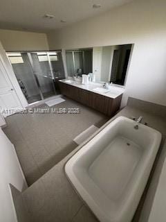 full bath featuring double vanity and a shower stall