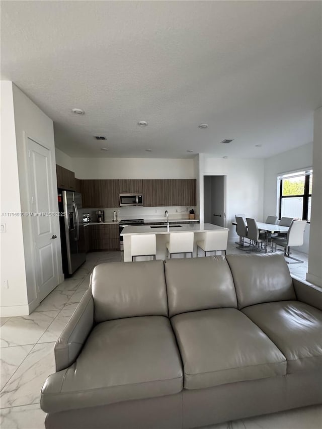 4409 SW 173rd Ave, Miramar, FL 33029 - living room featuring light marble finish floors and baseboards