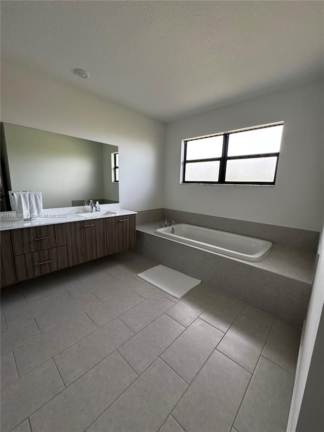 4409 SW 173rd Ave, Miramar, FL 33029 - full bath with a garden tub, vanity, tile patterned floors, and a textured ceiling
