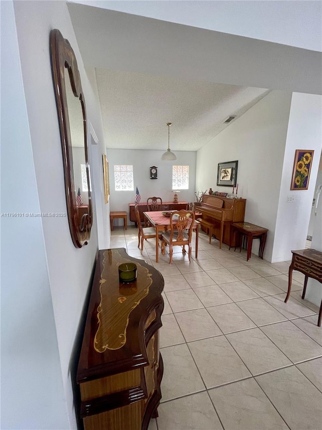 dining space with light tile patterned floors and visible vents