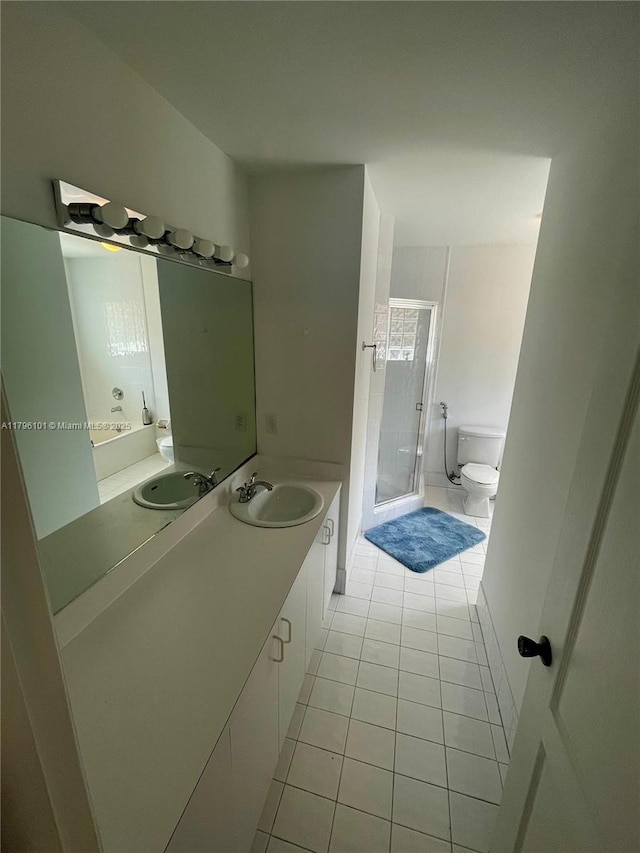 bathroom with vanity, tile patterned floors, toilet, and a shower stall
