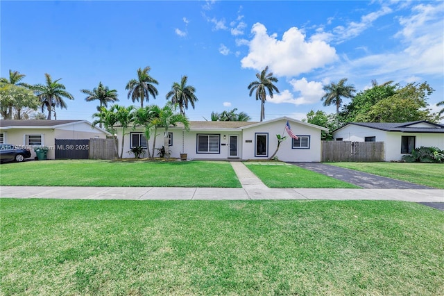 ranch-style house featuring stucco siding and asphalt driveway