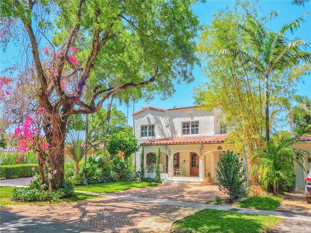 1229 Sorolla Ave, Coral Gables, FL 33134 - mediterranean / spanish-style home featuring a porch, a tile roof, and stucco siding