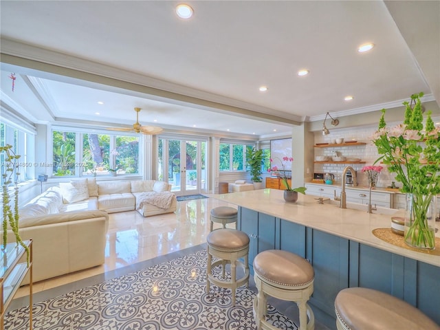 1229 Sorolla Ave, Coral Gables, FL 33134 - kitchen featuring open floor plan, recessed lighting, a breakfast bar area, backsplash, and french doors