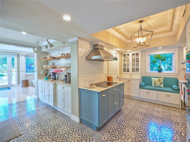 1229 Sorolla Ave, Coral Gables, FL 33134 - kitchen featuring exhaust hood, a raised ceiling, ornamental molding, black electric cooktop, and a chandelier