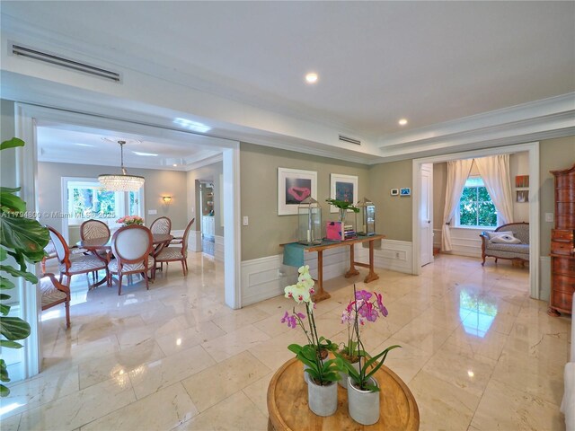 1229 Sorolla Ave, Coral Gables, FL 33134 - living room featuring crown molding, wainscoting, a decorative wall, and light marble finish floors