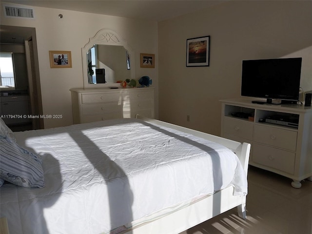 tiled bedroom with visible vents