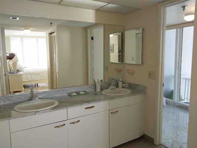 full bath featuring a sink and a healthy amount of sunlight