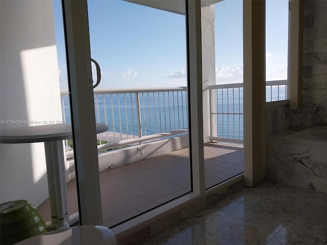 interior space featuring a water view and marble finish floor