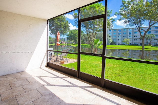 unfurnished sunroom with a water view and plenty of natural light