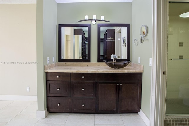 full bath with vanity, baseboards, tile patterned floors, and a shower stall