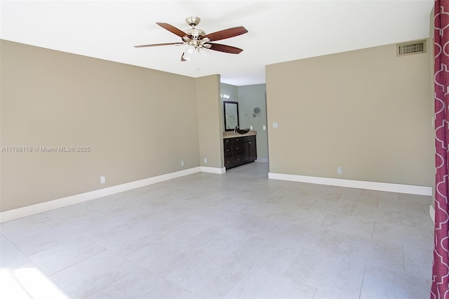 empty room featuring visible vents, baseboards, ceiling fan, and light tile patterned floors