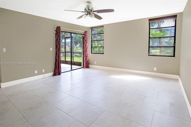 unfurnished room featuring light tile patterned floors, baseboards, and ceiling fan