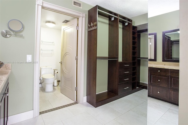 full bath with visible vents, tile patterned flooring, toilet, and vanity